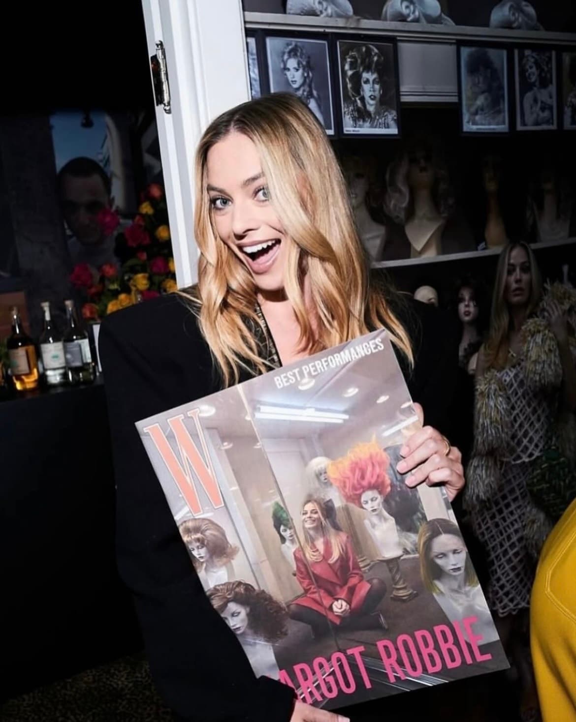 Margot Robbie holding the W Magazine Best Performances issue inside Outfitters Wig